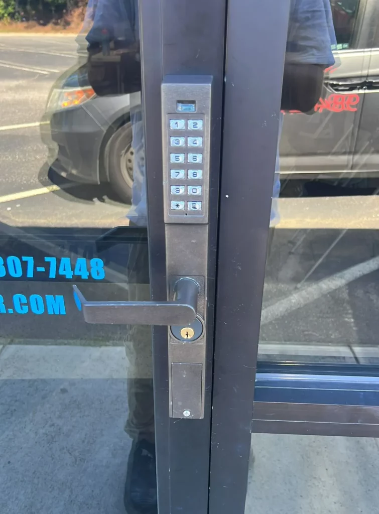 Locksmith Raleigh technician installing a commercial high-security lock on an office door in Raleigh NC