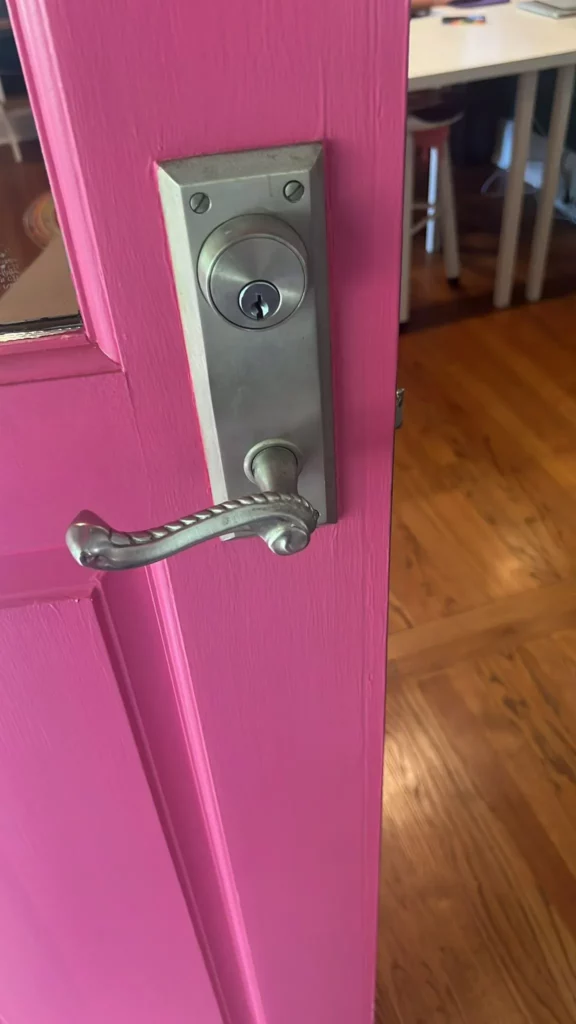 Locksmith repairing a residential deadbolt lock on a front door in Raleigh North Carolina