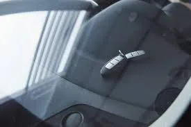 Car keys visible through a rear window inside a locked trunk compartment.