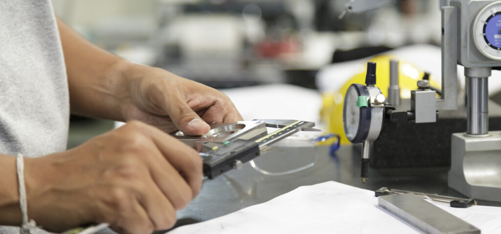 Close-up of a technician scanning a magnetic key on a calibration device inside a Raleigh locksmith workshop.