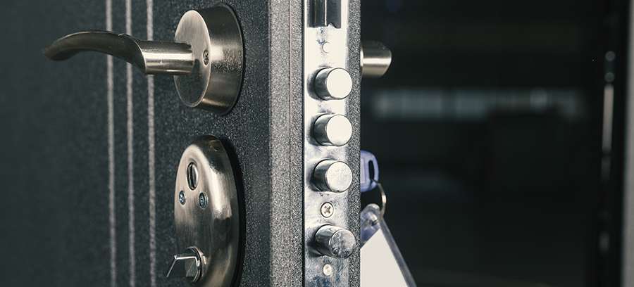 Technician installing a high-security lock on a steel door in Raleigh North Carolina