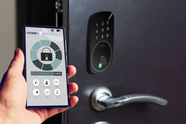 Technician pairing a new electronic lock to a homeowner’s smartphone app in Raleigh.