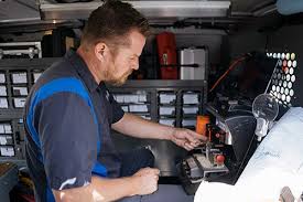 Technician verifying a key copy alignment using a digital key gauge inside a Raleigh locksmith shop.